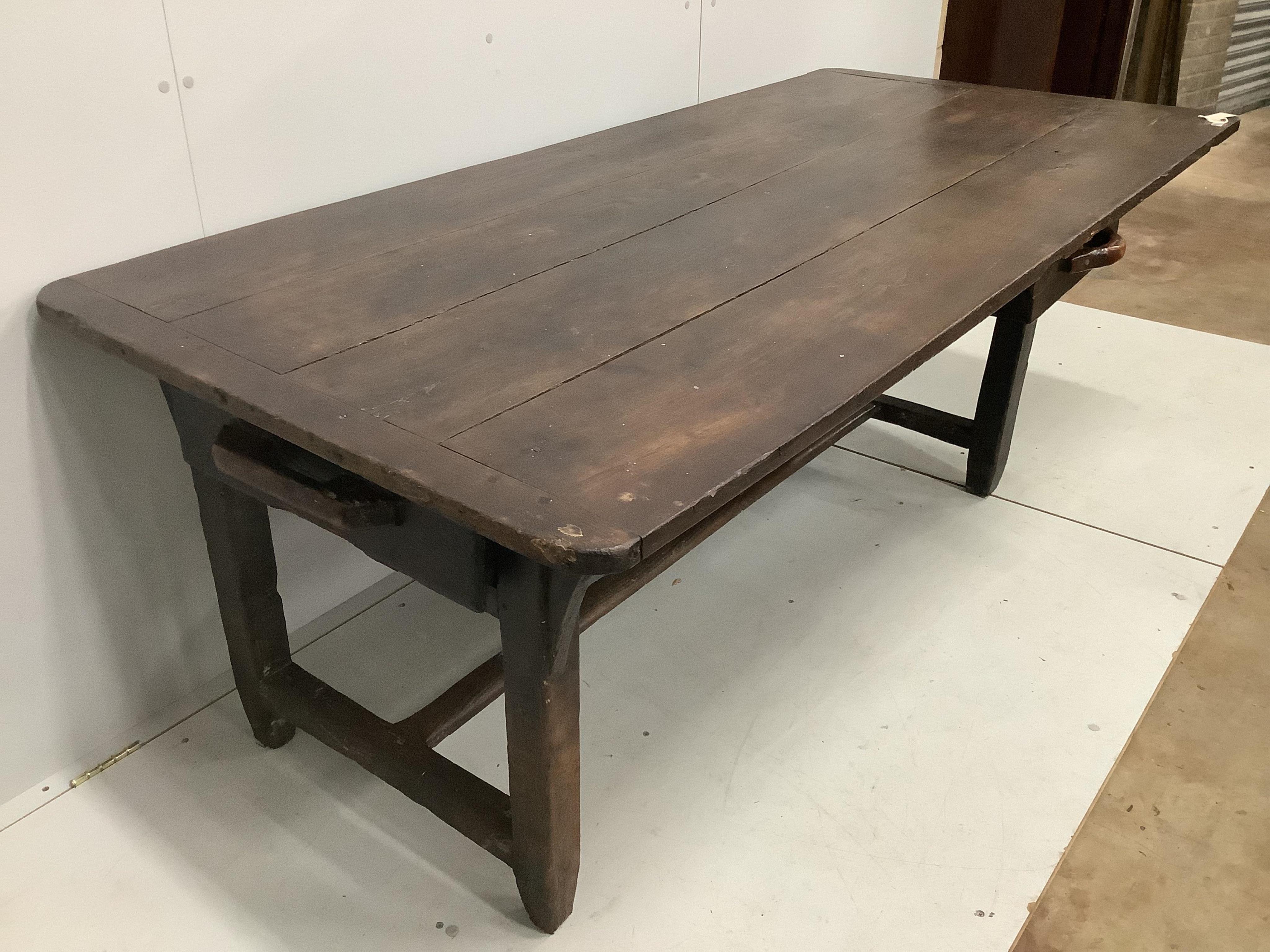 A 19th century French oak plank top kitchen table, width 198cm, depth 92cm, height 71cm, together with a pair of 19th century French oak benches, length 200cm, depth 24cm, height 42cm. Condition - fair